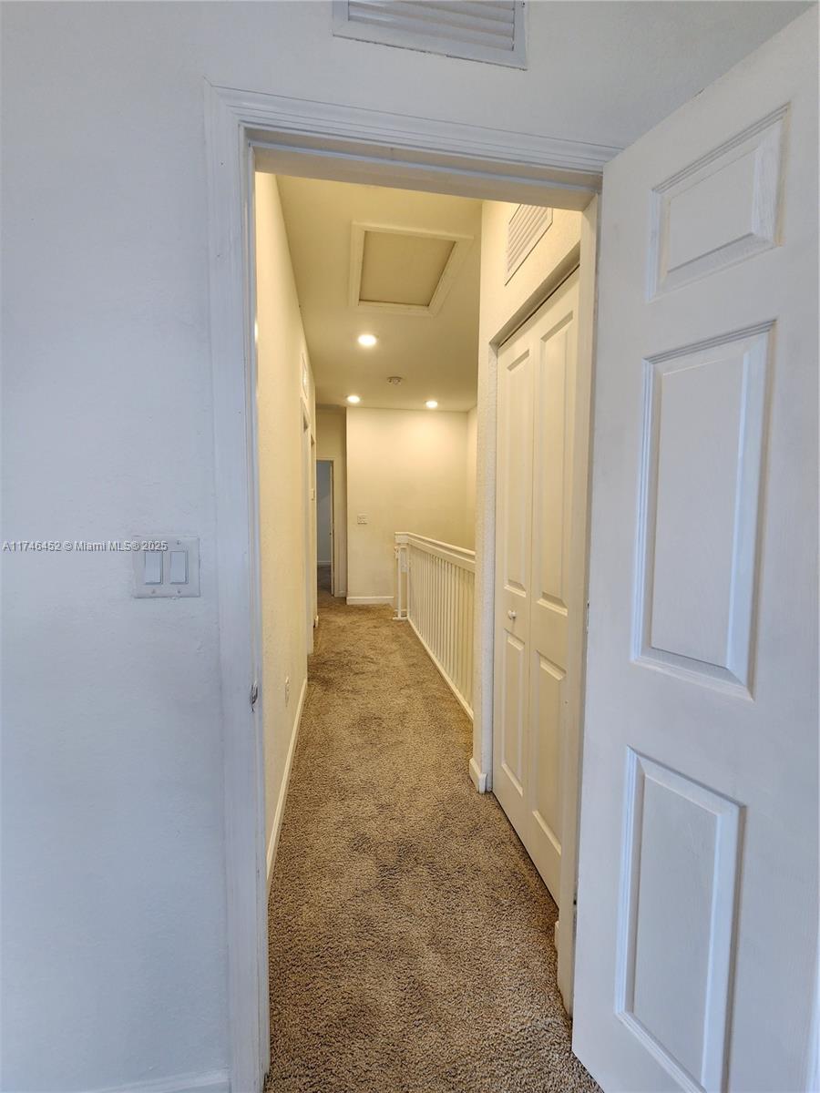18232 Southwest 148th Road, Unit 18232 Miami, FL 33187 - Photo 19 of 44 a view of a hallway with wooden floor