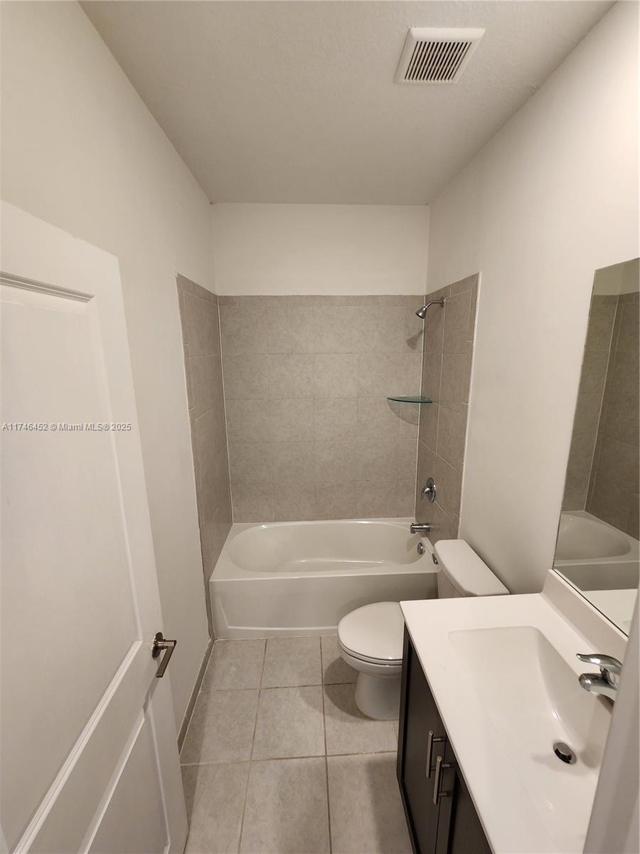 18232 Southwest 148th Road, Unit 18232 Miami, FL 33187 - Photo 23 of 44 a bathroom with a sink a toilet and shower