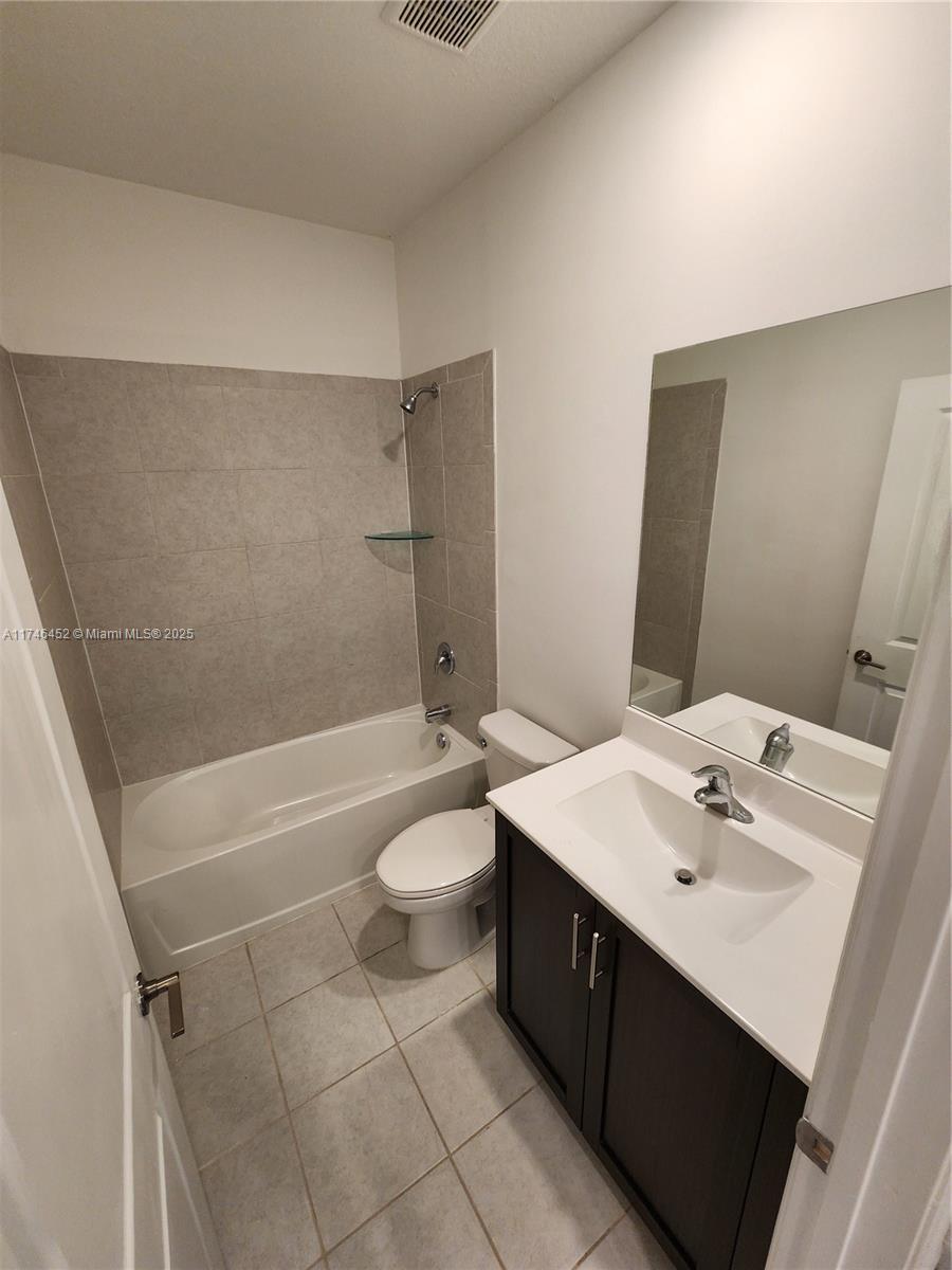 18232 Southwest 148th Road, Unit 18232 Miami, FL 33187 - Photo 24 of 44 a bathroom with a sink a toilet and bathtub
