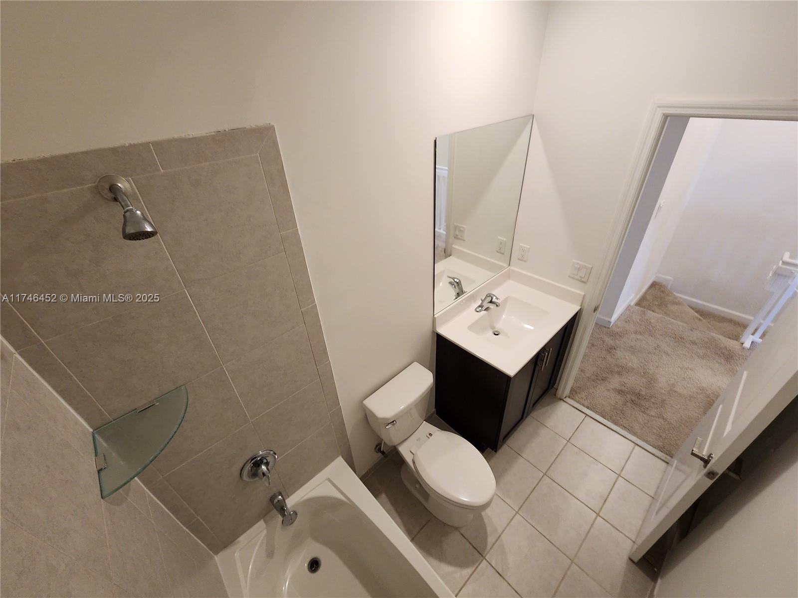 18232 Southwest 148th Road, Unit 18232 Miami, FL 33187 - Photo 25 of 44 a bathroom with a sink mirror and toilet