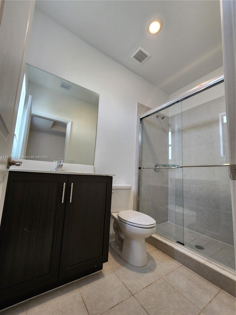 18232 Southwest 148th Road, Unit 18232 Miami, FL 33187 - Photo 28 of 44 a bathroom with a sink a toilet and shower