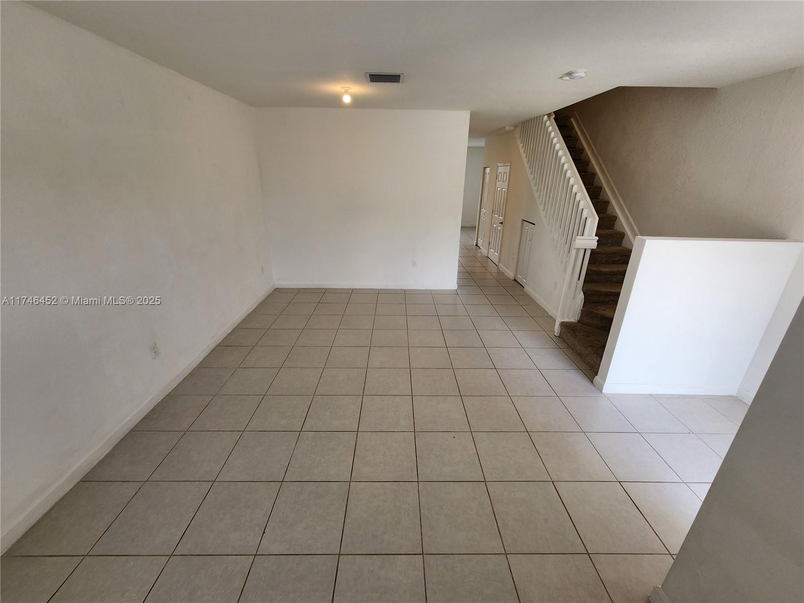 18232 Southwest 148th Road, Unit 18232 Miami, FL 33187 - Photo 4 of 44 a view of an empty room with wooden floor