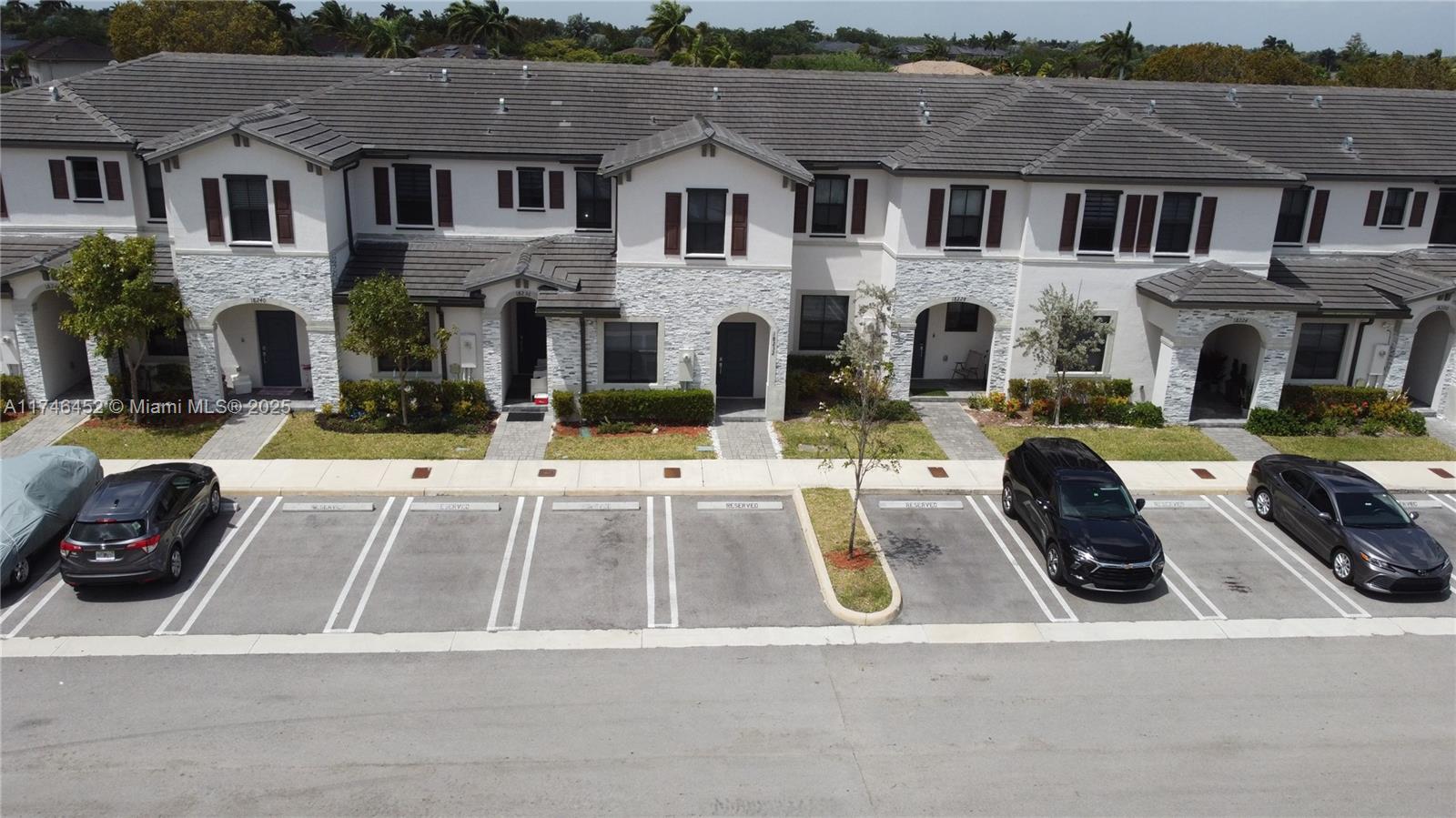 18232 Southwest 148th Road, Unit 18232 Miami, FL 33187 - Photo 43 of 44 a view of multiple houses with a outdoor space