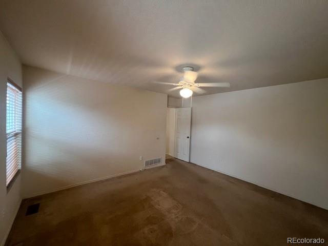 5752 Gallantry Lane Colorado Springs, CO 80923 - Photo 17 of 35 an empty room with a chandelier fan and windows