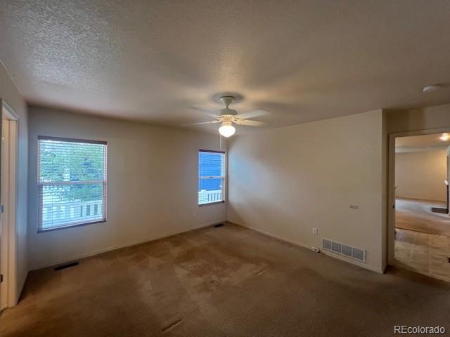 5752 Gallantry Lane Colorado Springs, CO 80923 - Photo 18 of 35 a view of a livingroom with a ceiling fan and window
