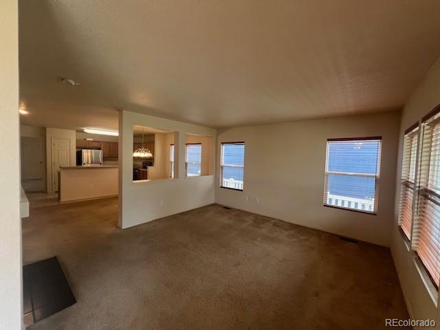 5752 Gallantry Lane Colorado Springs, CO 80923 - Photo 3 of 35 a view of a big room with windows and fireplace