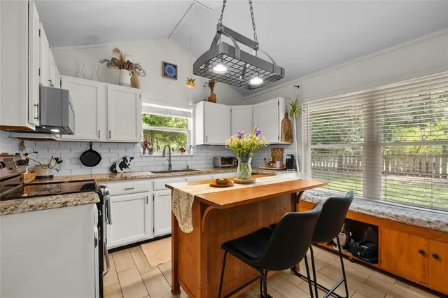 a dining table with chairs and window