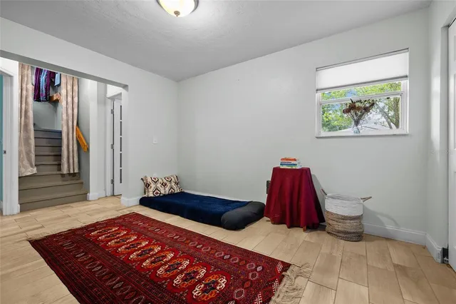 a bedroom with a bed and a painting on the wall