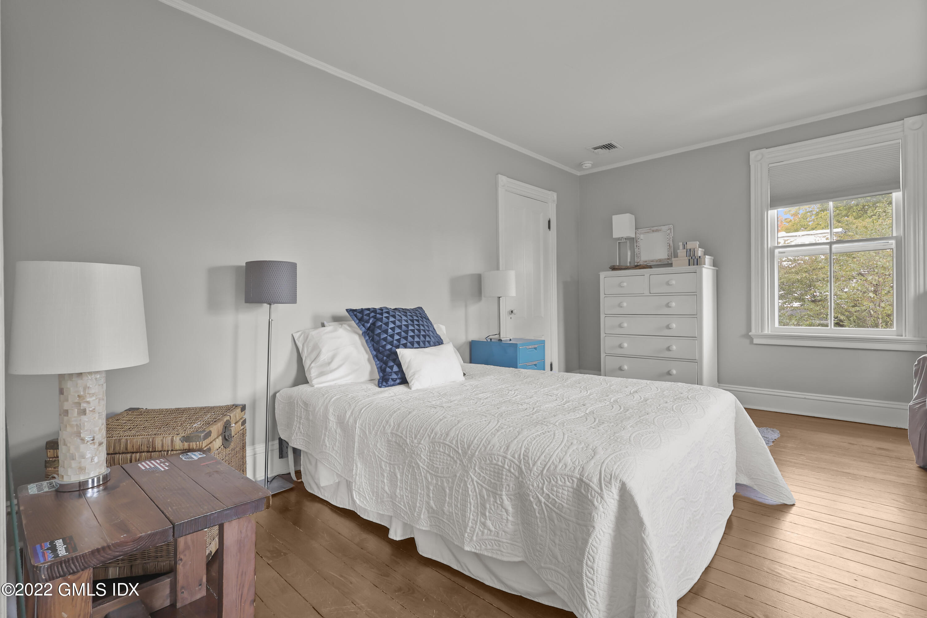 60 River Road Cos Cob, CT 06807 - Photo 19 of 31 a bedroom with a bed and wooden floor