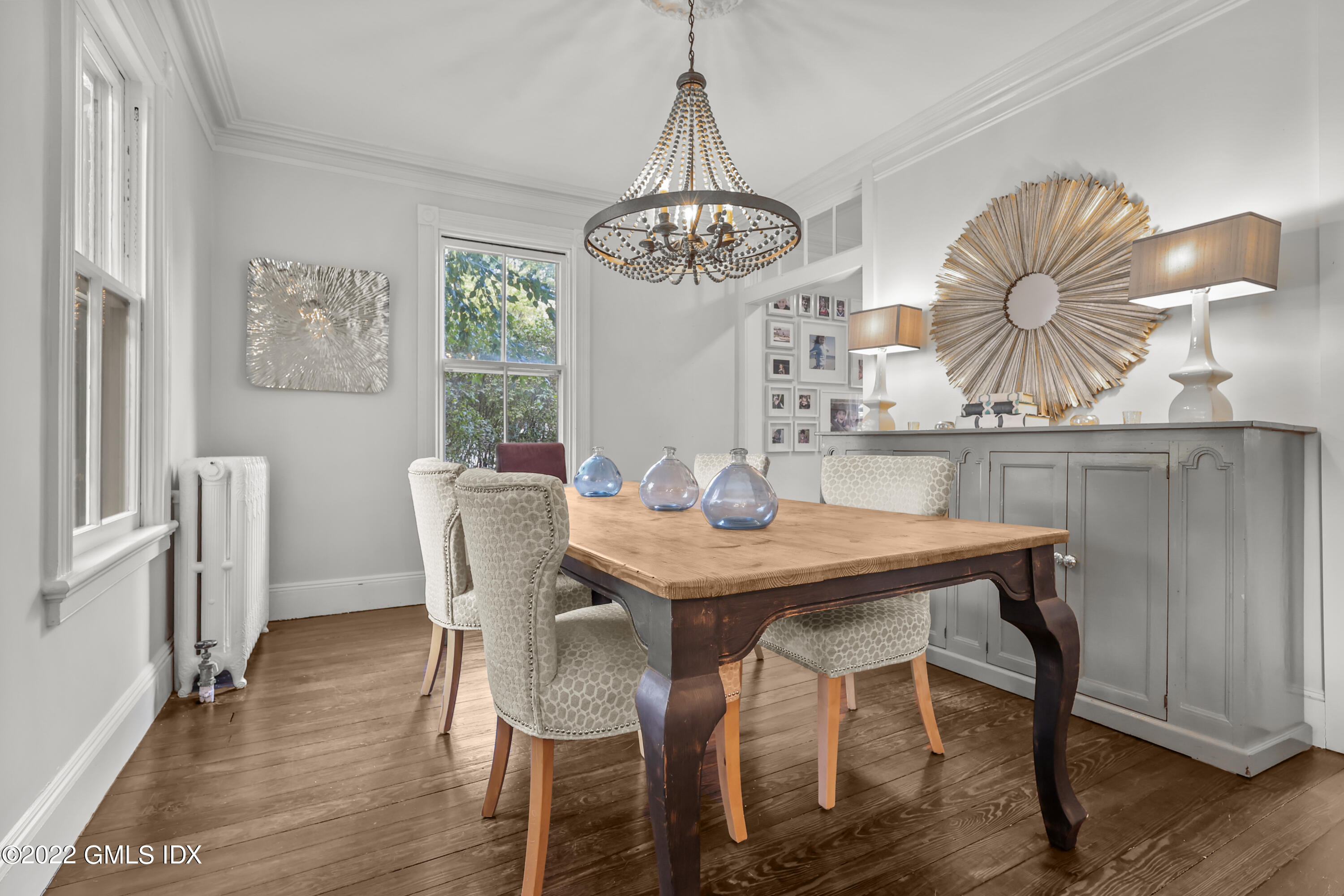 60 River Road Cos Cob, CT 06807 - Photo 8 of 31 a view of a dining room with furniture wooden floor and chandelier