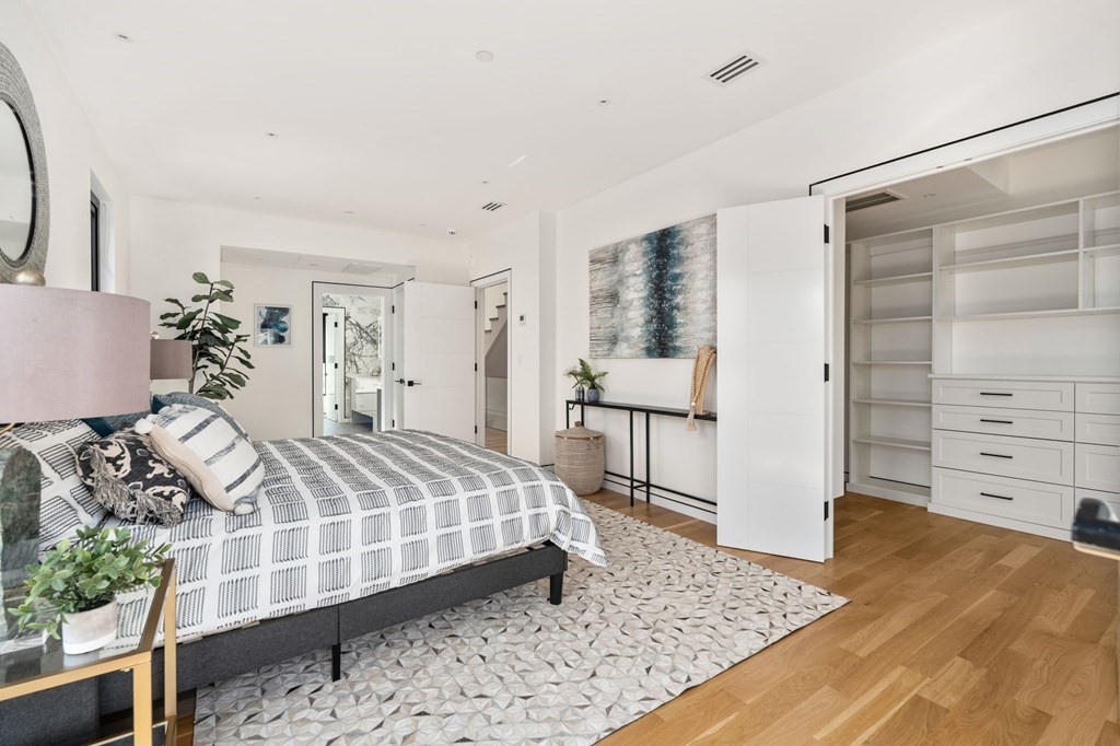 43 Stearns Road, Unit SF Brookline, MA 02446 - Photo 11 of 19 a bedroom with a large bed and wooden floor