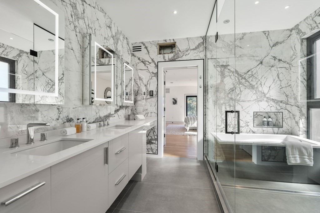 43 Stearns Road, Unit SF Brookline, MA 02446 - Photo 12 of 19 a bathroom with a double vanity sink a mirror a bathtub and shower