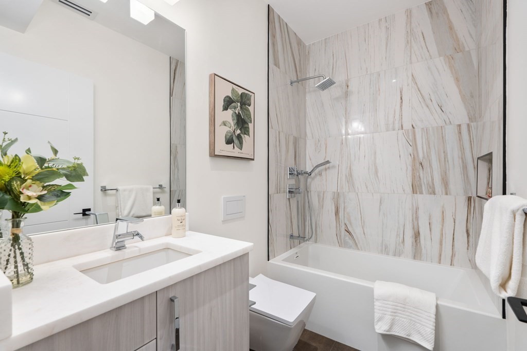 43 Stearns Road, Unit SF Brookline, MA 02446 - Photo 14 of 19 a bathroom with a sink a bathtub and a mirror