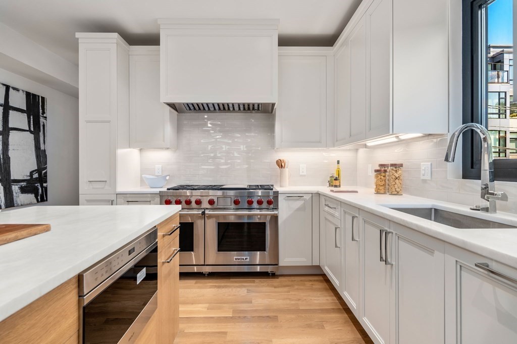 43 Stearns Road, Unit SF Brookline, MA 02446 - Photo 2 of 19 a kitchen with a stove top oven and sink