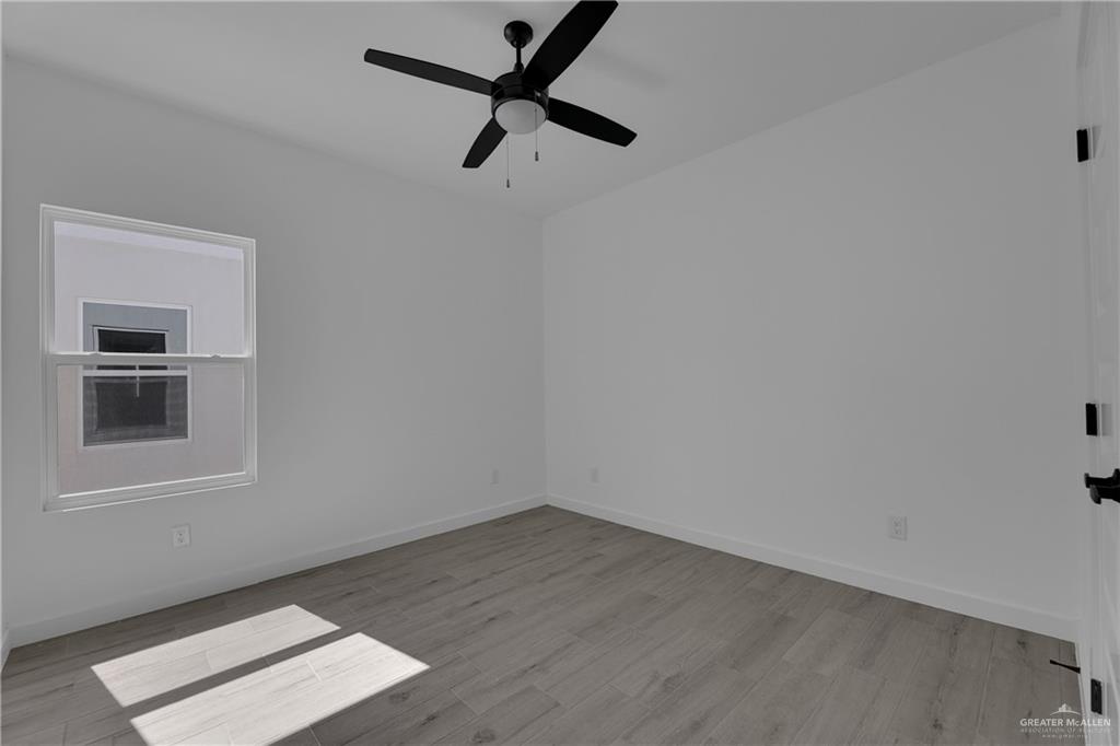 2509 Mockingbird Road, Unit B Weslaco, TX 78596 - Photo 9 of 11 Spare room featuring ceiling fan and light hardwood / wood-style floors