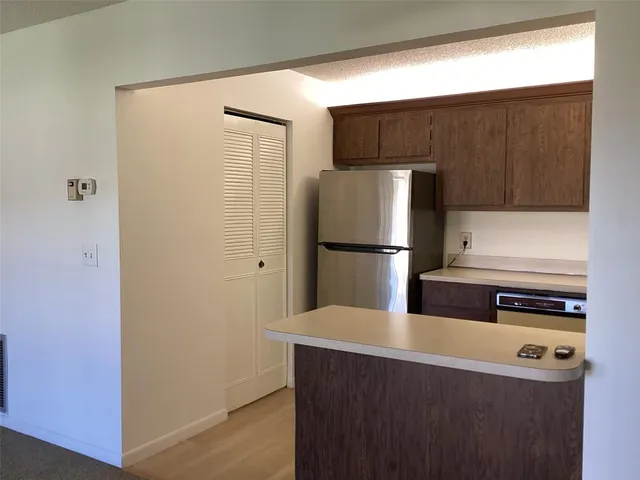a kitchen with a refrigerator and a stove