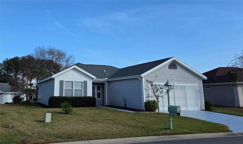 13185 Southeast 93rd Terrace Road Summerfield, FL 34491 - Photo 1 of 48 a front view of a house with a yard