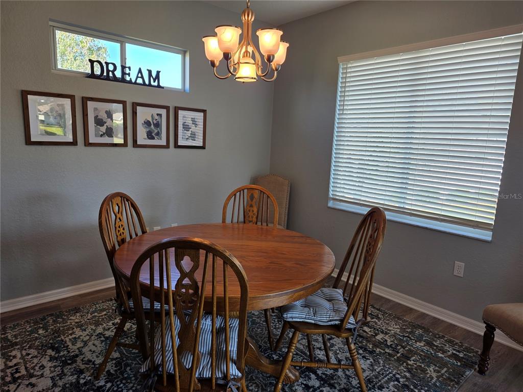 13185 Southeast 93rd Terrace Road Summerfield, FL 34491 - Photo 13 of 48 a view of a dining room with furniture and chandelier