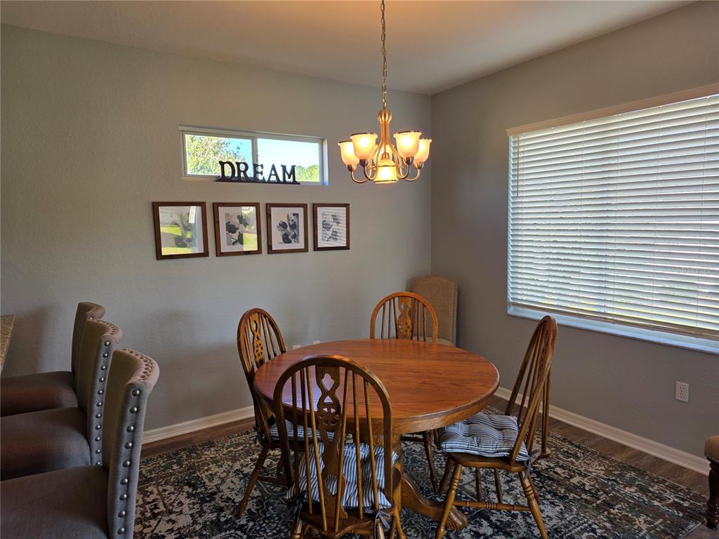 13185 Southeast 93rd Terrace Road Summerfield, FL 34491 - Photo 14 of 48 a view of a dining room with furniture and window