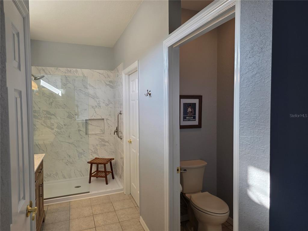 13185 Southeast 93rd Terrace Road Summerfield, FL 34491 - Photo 18 of 48 a bathroom with a toilet and a shower