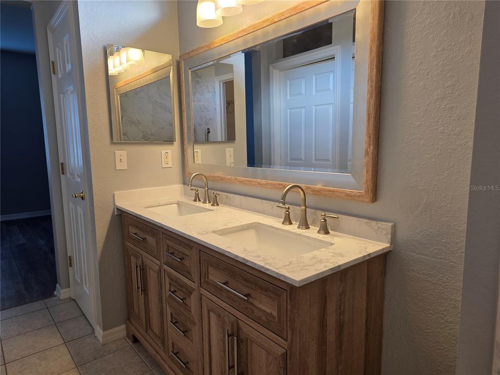 13185 Southeast 93rd Terrace Road Summerfield, FL 34491 - Photo 20 of 48 a bathroom with a sink and a mirror