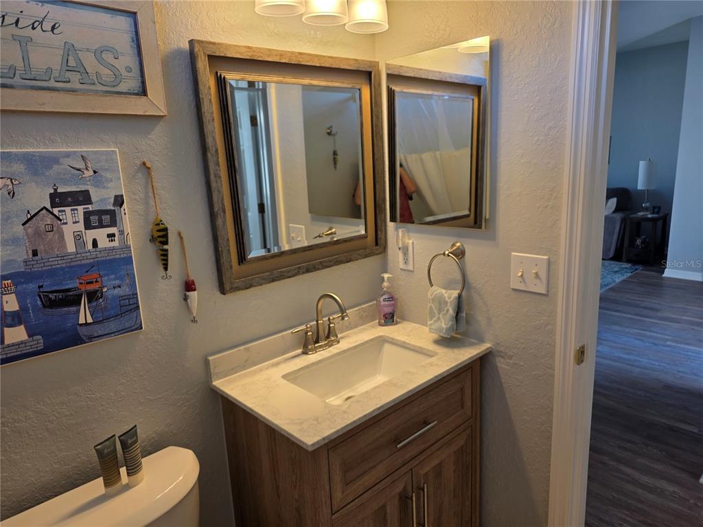 13185 Southeast 93rd Terrace Road Summerfield, FL 34491 - Photo 29 of 48 a bathroom with a toilet sink and mirror