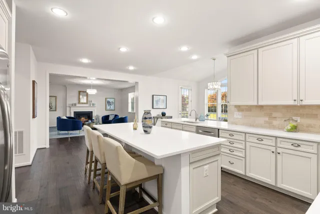a living room with furniture windows and a dining table