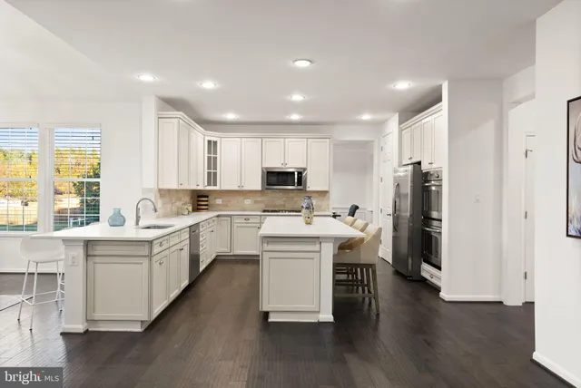 a white bath tub sitting in a bathroom next to a window