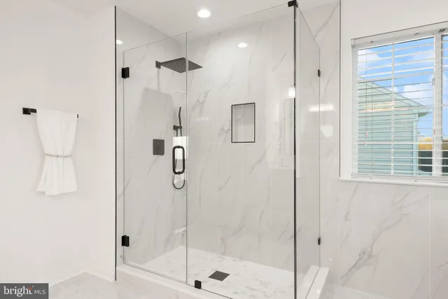 a living room with furniture wooden floor and a large window