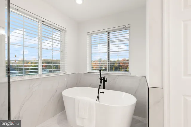 a dining room with furniture a chandelier and wooden floor