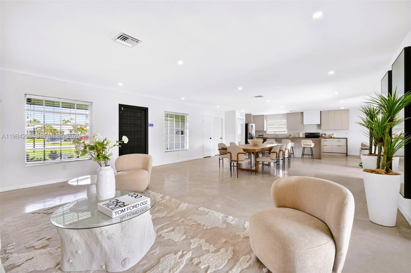 1119 North 46th Terrace Hollywood, FL 33021 - Photo 1 of 41 a living room with furniture potted plant and open kitchen view