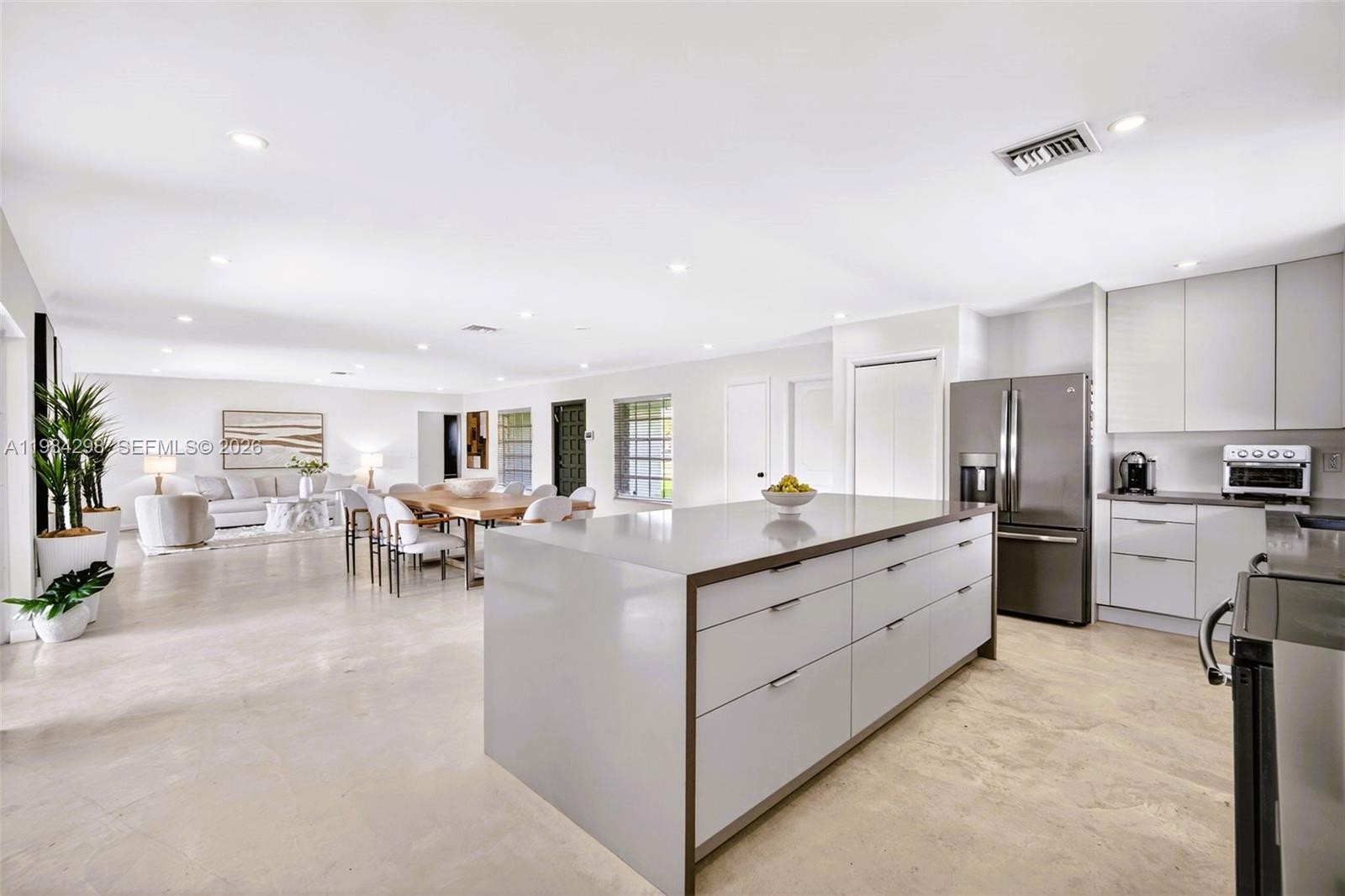 1119 North 46th Terrace Hollywood, FL 33021 - Photo 15 of 41 a kitchen with sink cabinets and living room view