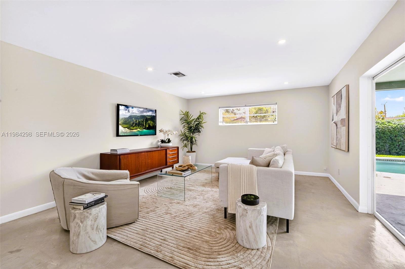 1119 North 46th Terrace Hollywood, FL 33021 - Photo 18 of 41 a living room with fireplace furniture and a large window