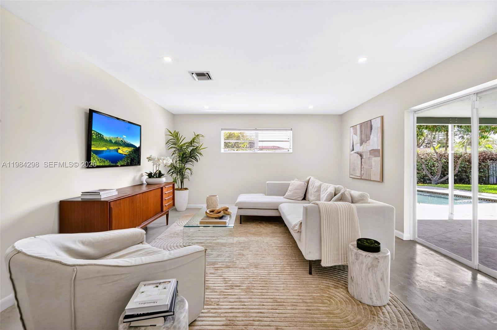 1119 North 46th Terrace Hollywood, FL 33021 - Photo 19 of 41 a living room with furniture and a flat screen tv