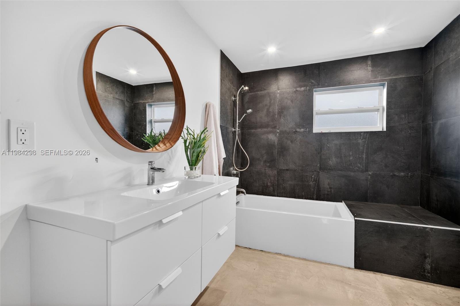 1119 North 46th Terrace Hollywood, FL 33021 - Photo 24 of 41 a bathroom with a bathtub a sink and a mirror