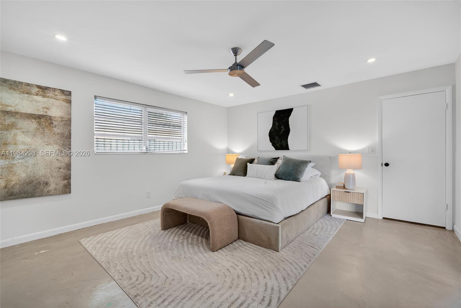 1119 North 46th Terrace Hollywood, FL 33021 - Photo 27 of 41 a bedroom with a large bed and a chandelier