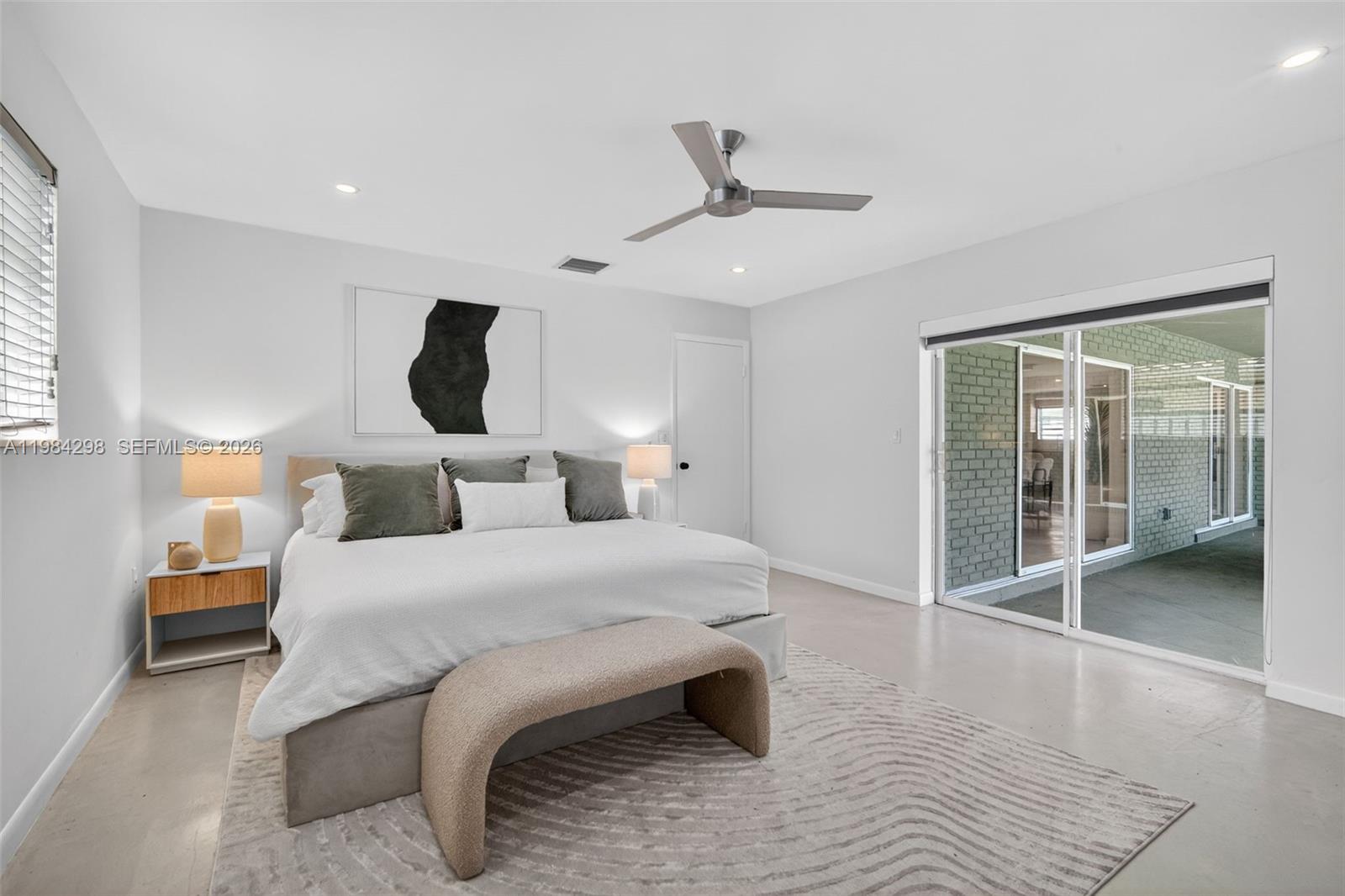 1119 North 46th Terrace Hollywood, FL 33021 - Photo 29 of 41 a bedroom with a large bed and a large window