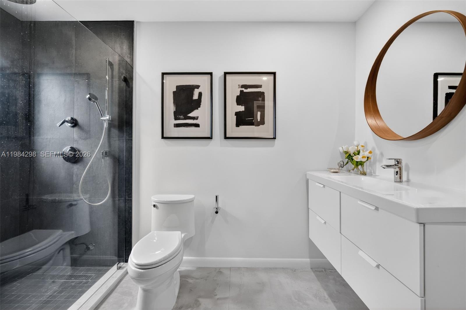 1119 North 46th Terrace Hollywood, FL 33021 - Photo 31 of 41 a bathroom with a toilet a sink and mirror