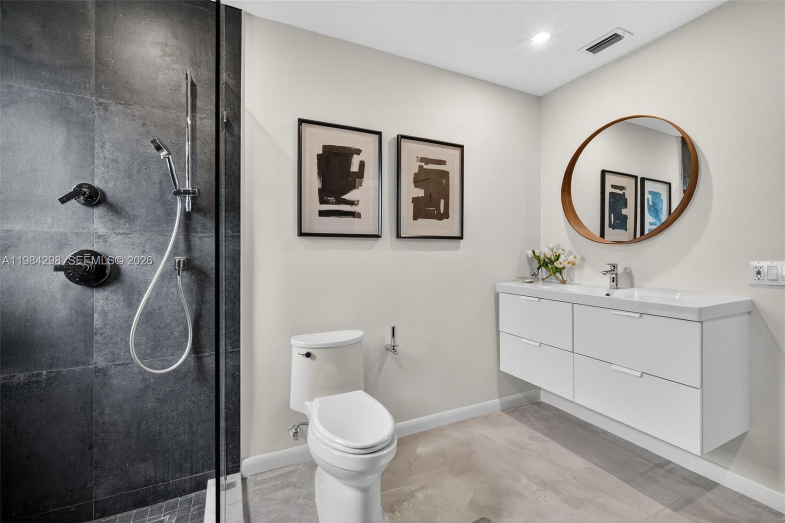 1119 North 46th Terrace Hollywood, FL 33021 - Photo 33 of 41 a bathroom with a toilet a sink and mirror