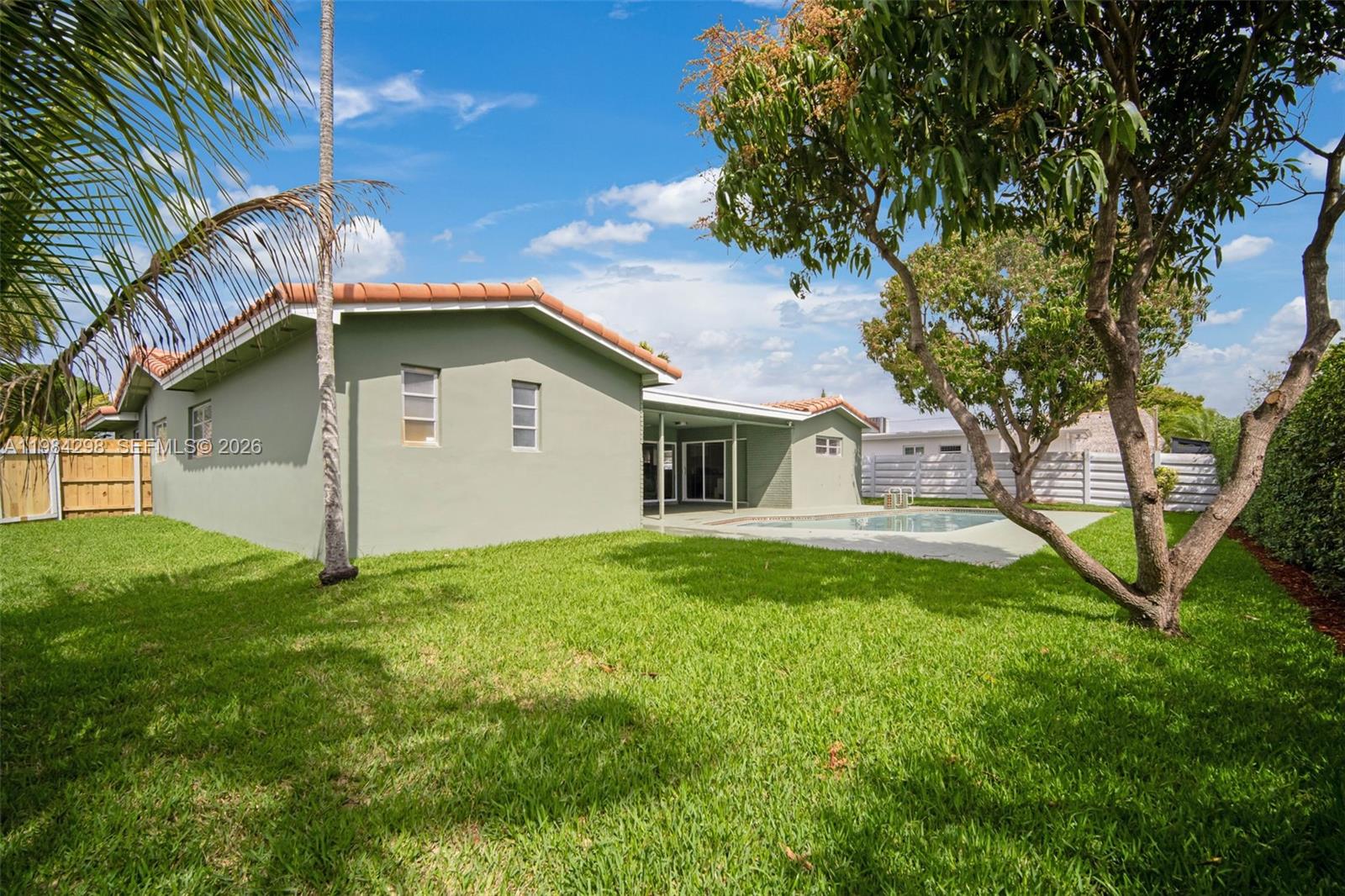 1119 North 46th Terrace Hollywood, FL 33021 - Photo 36 of 41 a house with green field in front of it