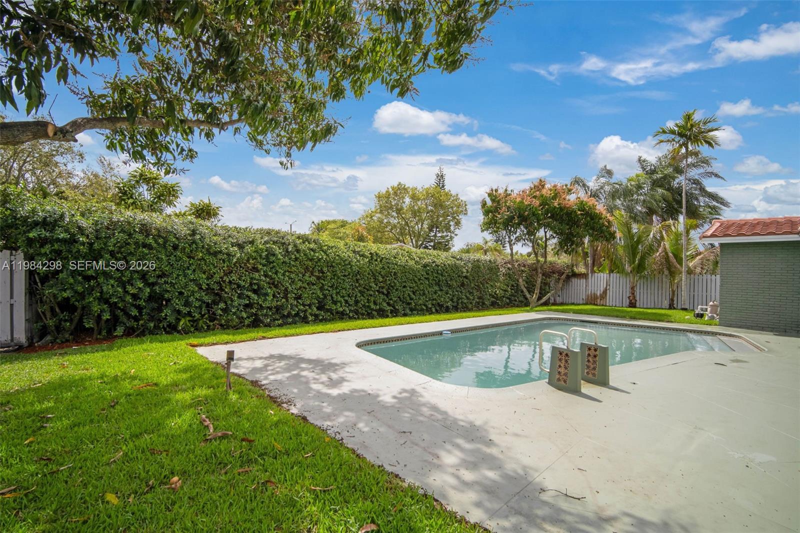 1119 North 46th Terrace Hollywood, FL 33021 - Photo 38 of 41 a view of a swimming pool with a yard