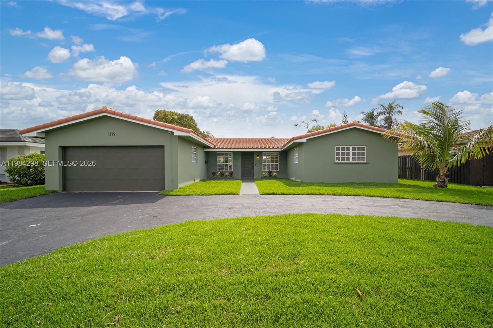 1119 North 46th Terrace Hollywood, FL 33021 - Photo 5 of 41 a view of a white house with a swimming pool and a yard