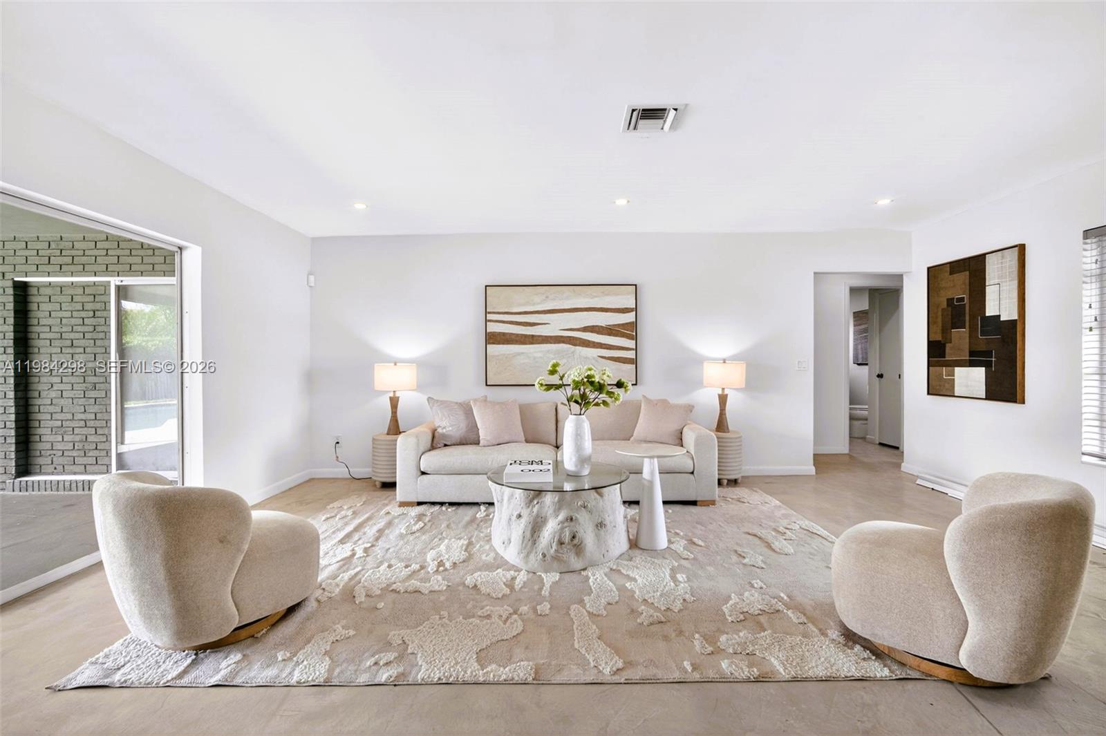 1119 North 46th Terrace Hollywood, FL 33021 - Photo 9 of 41 a living room with furniture lamp and window