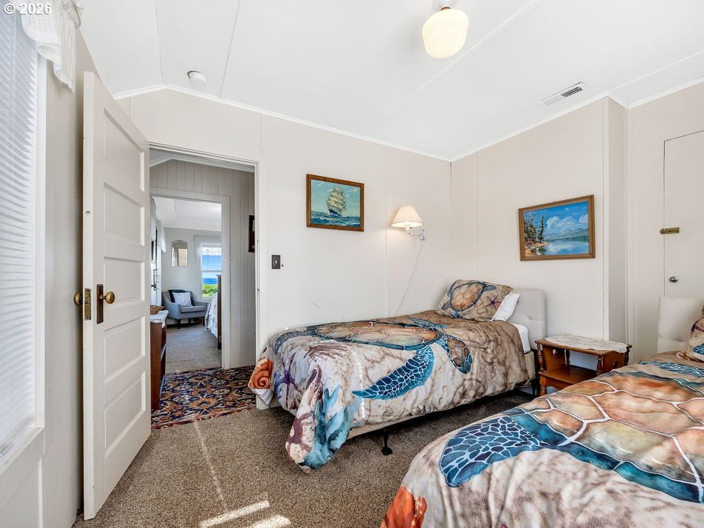 1081 South Promenade Seaside, OR 97138 - Photo 20 of 39 a bedroom with two beds and a walk in closet