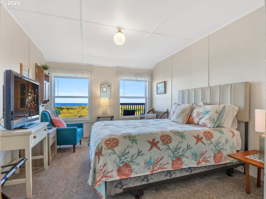 1081 South Promenade Seaside, OR 97138 - Photo 22 of 39 a bedroom with a bed a couch and a flat tv screen on dresser