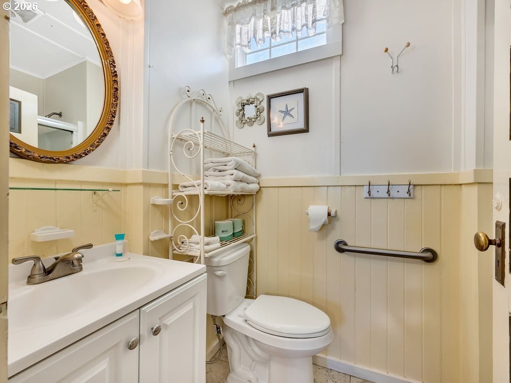 1081 South Promenade Seaside, OR 97138 - Photo 28 of 39 a bathroom with a sink mirror vanity and toilet