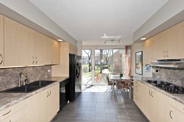 144 Wellington Road Northbrook, IL 60062 - Photo 5 of 20 a large kitchen with stainless steel appliances a lot of counter space and a large window