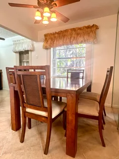 a view of a dining room with furniture window and outside view