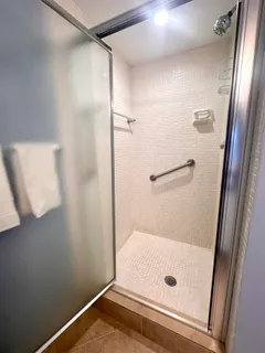 a bathroom with a glass shower door