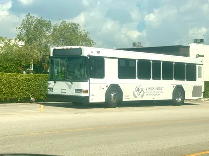 a front view of a building with a garden